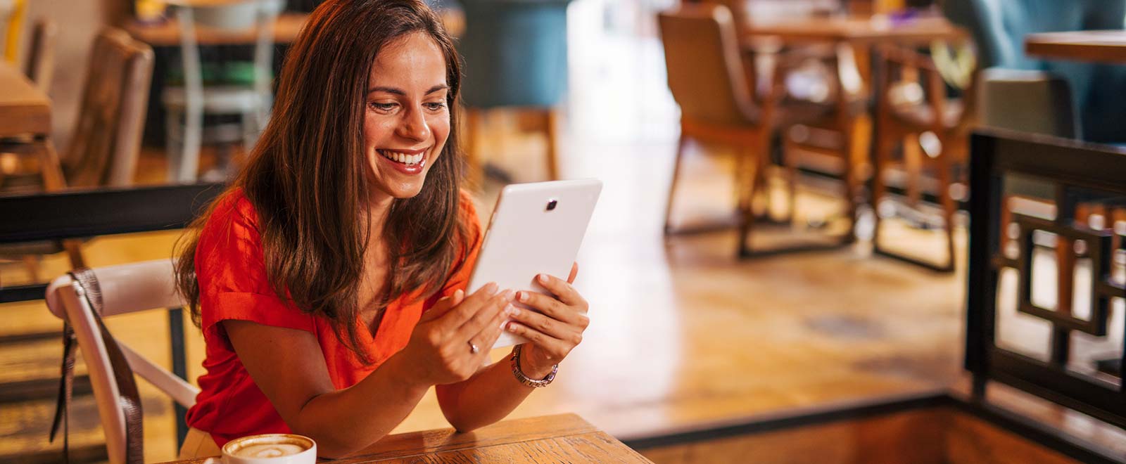 Woman using tablet in coffee shop