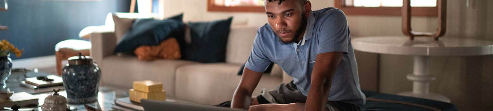 Young man looking at his laptop.