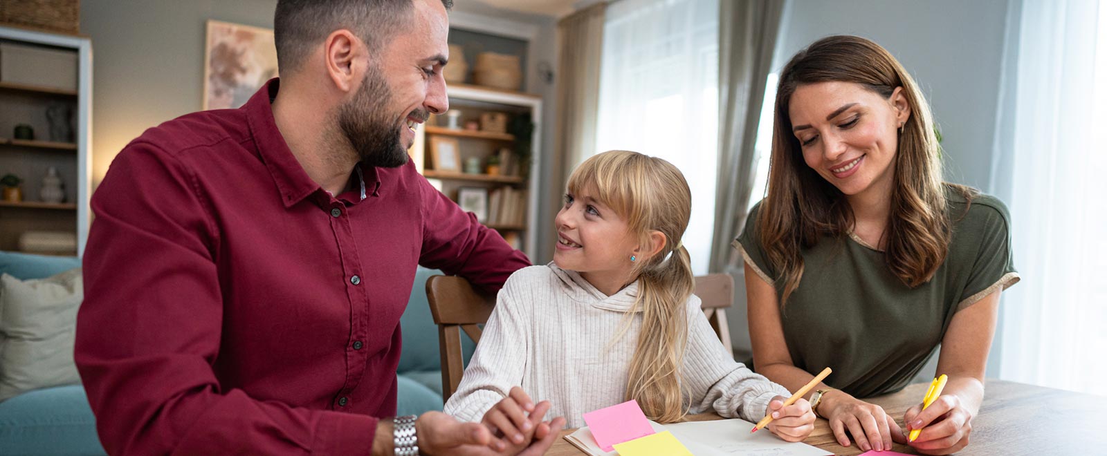 Young family drawing in kitchen